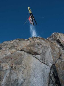 Buck on his ski's, skiing off a cliff.